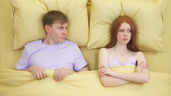 Irritated Millennial Young Couple in Bed Does't Pay Attention To Each Other Not Talking