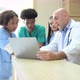 A medical professor gives advice on patient examinations to medical students practicing - VideoHive Item for Sale