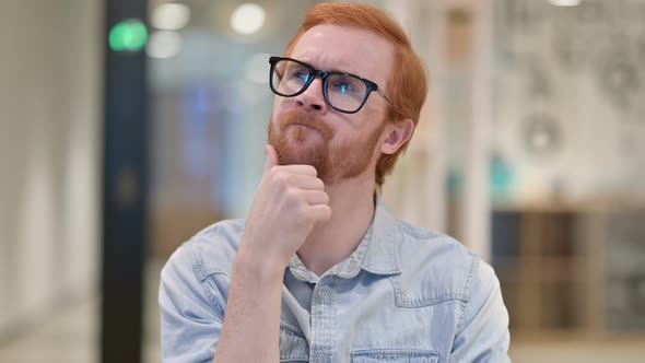 Portrait of Pensive Casual Redhead Man Thinking About Something  alt