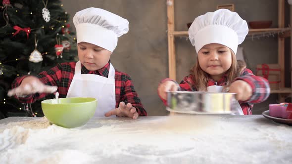 Brother and Sister Cooks Prepare Dough for Cookies From Flour alt