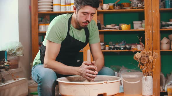 Pottery - Potter Master Is Pulling Clay in Length on a Potter's Wheel alt