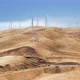 Epic View of Working Windturbines Located on the Golden Hills Under the Blue Sky - VideoHive Item for Sale