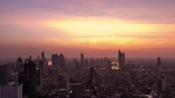 Bangkok business district city center and Chao Phraya River, day to night, zoom out – Time Lapse