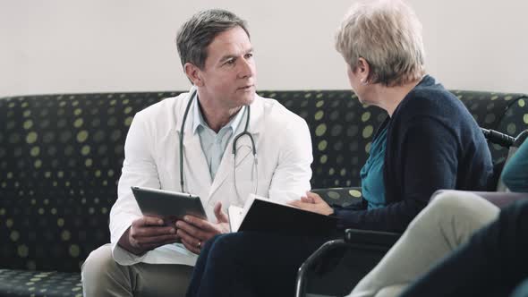 Doctor consulting patient in hospital waiting room