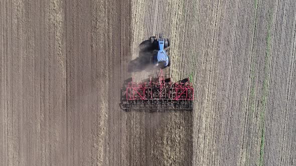 Agricultural Tractor in the Field Fluff the Earth