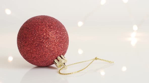 Red shiny  bauble with sequins close-up 4K 2160p 30fps UltraHD footage - Christmas ornament and fair alt