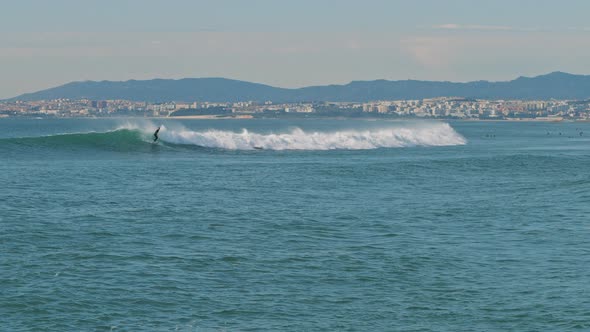Surfer catching wave in the  Atlantic ocean near the Lisbon coast, Portugal.  alt