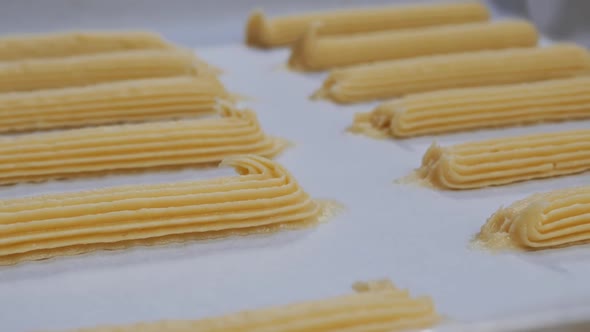 Dolly Shot French Custard Eclairs in a Baking Sheet Before Baking alt