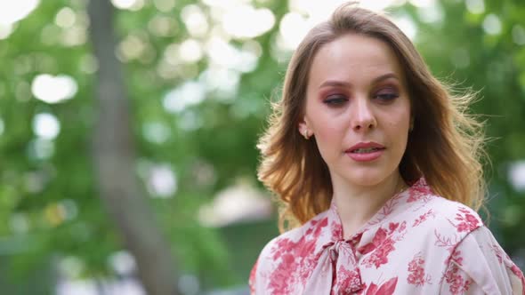 Attractive Young Woman with Smoky Eyes Make Up Look at Camera Smile Stand in the City Park Slow alt