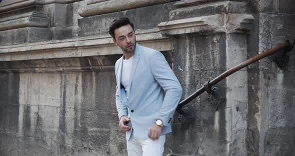 Young Man Presents Designer Clothes, Is Photographed Near The Old Castle alt