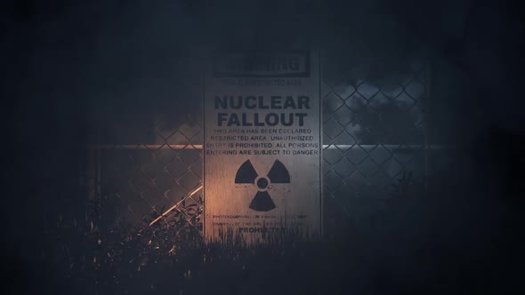 Nuclear Fallout Warning Sign On A Fence In A Storm alt