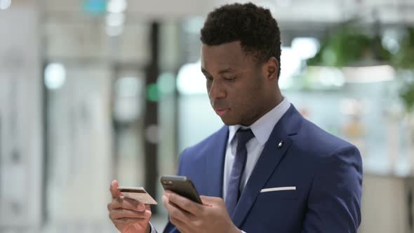 Online Shopping Payment Success on Smartphone By African Businessman alt