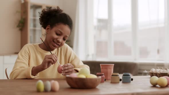Happy Girl Painting Eggs on Easter alt