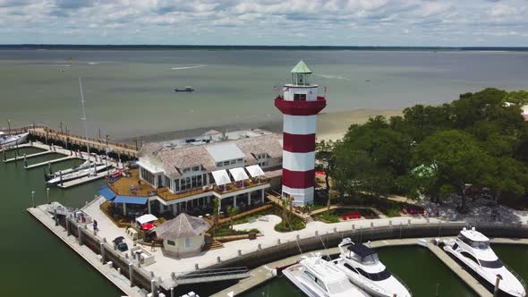 A wide orbiting shot of the lighthouse at Harbor Town on Hilton Head Island, SC alt