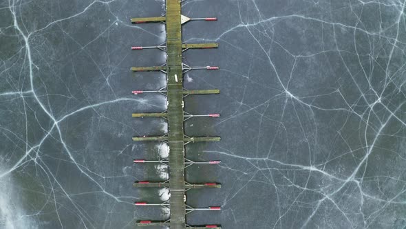 Empty Wooden Jetty At Steinsfjorden Lake With Cracked Ice. - aerial alt