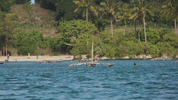 View From Ocean to Wooden Fishing Boats Anchored Near Coast of African Village alt