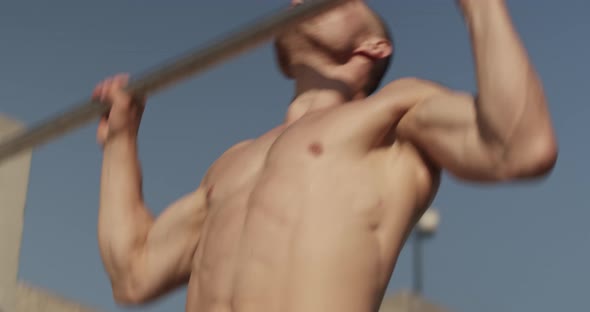 Sportsman Doing Pull Ups on Bar alt