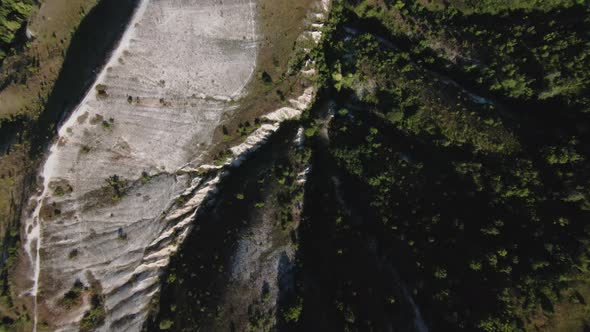 Aerial POV Footage of a Flight Over a White Mountain Range alt