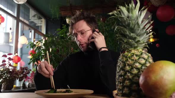Guy Talking on the Phone at the Dinner Table alt