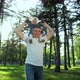 Sunlight on Father Holding his Baby Girl on Shoulders in City Park - VideoHive Item for Sale