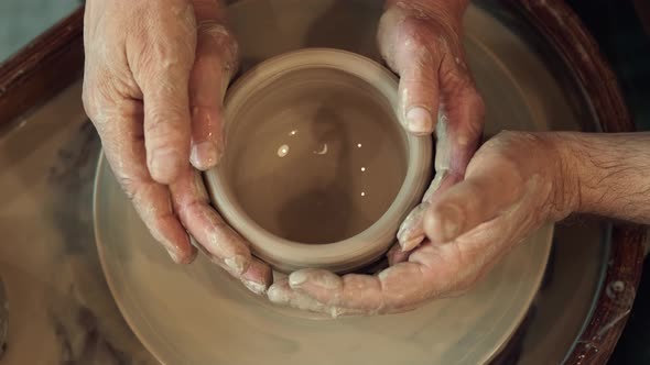 Senor Man Helps Senor Woman By Supporting Her Hands During the Art of Art alt