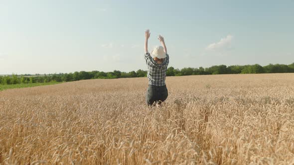 Woman runing fun across the wheat field. agriculture dream concept. girl farmer hands to sides runs alt