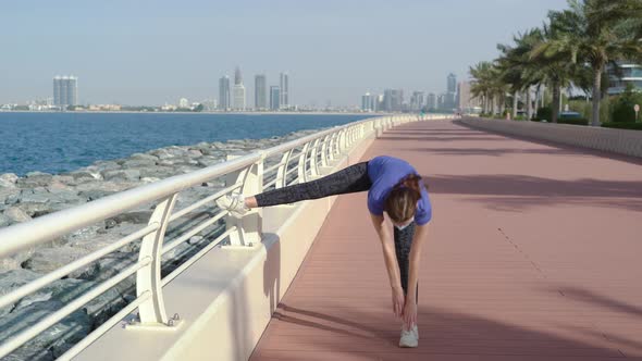 Girl in Mask Does Stretching Near Sea