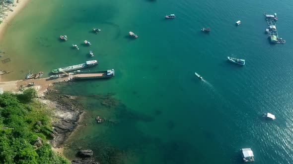 Tropical Shoreline with Nautical Vessels Moving in the Clear Bright Sea alt