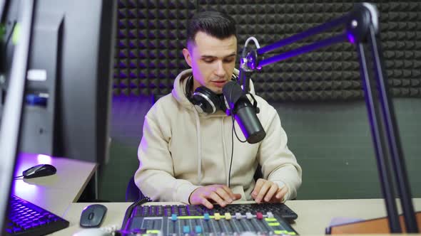 a Male Radio Dj in Between Broadcasts in a Radio Studio, Stock Footage