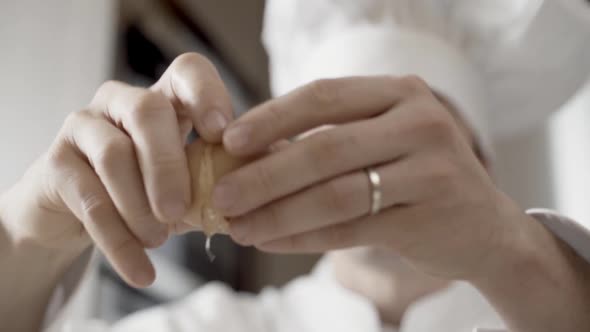 Closeup of Hands of a Chef Breaking Eggs