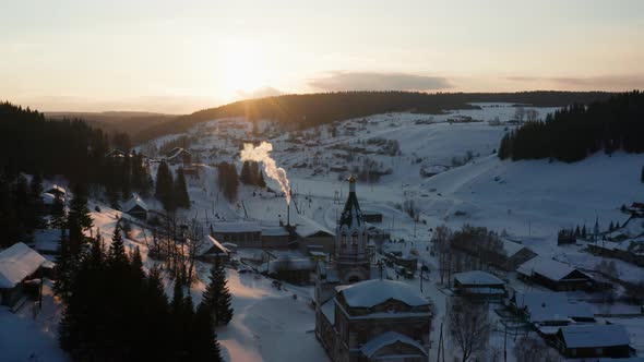 Aerial View of the Village at Sunset in Winter with Bright Sun alt