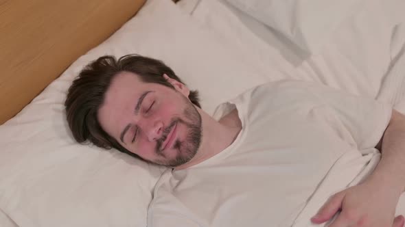 Casual Young Man Sleeping in Bed Peacefully alt
