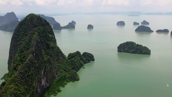 Fly sideways over green mountain at sea, Phang Nga bay, Thailand alt