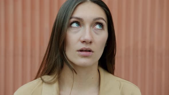 Slow Motion Closeup Portrait of Confused Young Woman Rolling Eyes Standing Outdoors alt