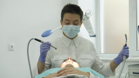 Dentist treating his patient alt