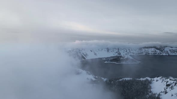 Drone video of volcanic caldera lake with clouds, Crater Lake, Oregon, USA alt