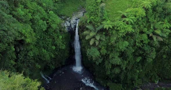 drone flight over the kedung kayang waterfall and the underlying water basin it creates in central j alt