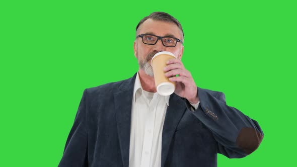 Rich Mature Man Walking and Drinking Coffee on a Green Screen Chroma Key alt