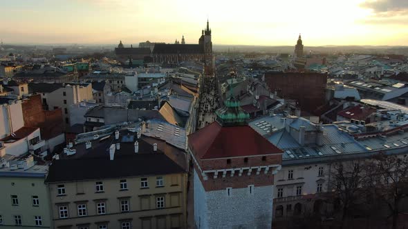 Drone passing Florian Gate and flying over Florianska street, Krakow, Poland alt