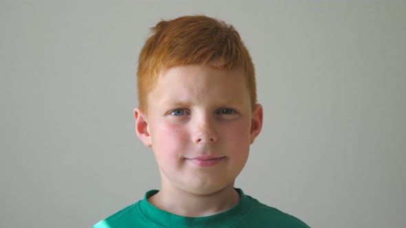 Adorable Kid Looking Into Camera with Joyful Smile Indoor alt