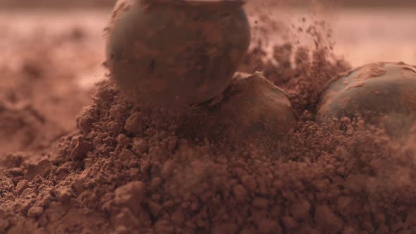 Chocolate truffles falling into chocolate powder in super slow motion.  Shot on Phantom Flex 4K high