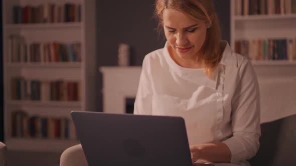 Blonde Female Using Computer in Apartment alt