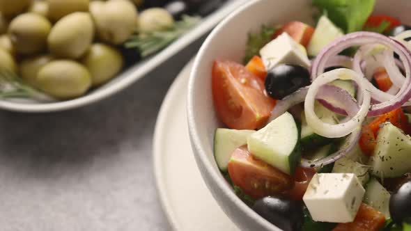 Salad is poured with olive oil	