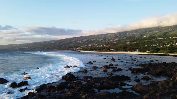 Drone footage of waves near the shore in the south of the Reunion island during sunset. alt