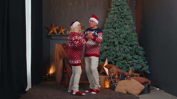 Cheerful Smiling Married Senior Couple Grandparents in Decorated Room Celebrating Christmas Together alt
