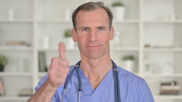 Portrait of Successful Middle Aged Doctor Showing Thumbs Up alt