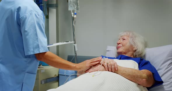 Female nurse adjusting iv drip  alt