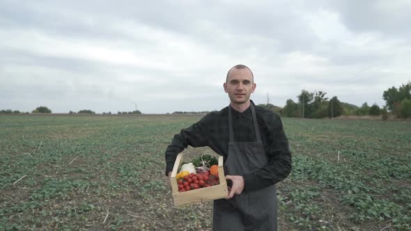 Farmer Holding a Box of Freshly Picked Organic Vegetables.