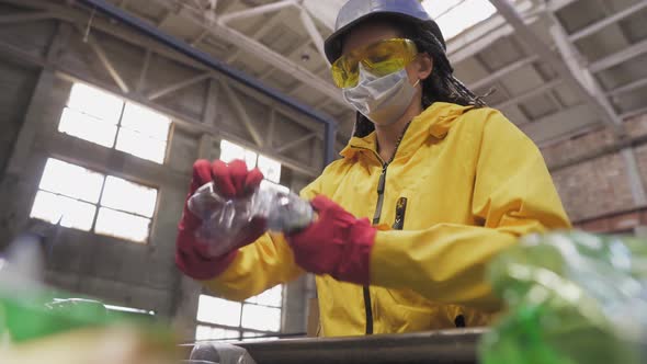 Womanvolunteer in Yellow and Transparent Protecting Glasses Hard Hat and Mask Sorting Used Plastic alt