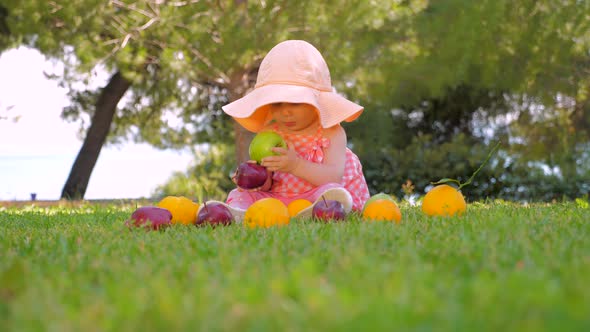 Child Playing with Fruits Outdoor. Baby Girl in Panama Having Fun Outdoor on Back Yard. Happy